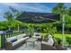 Inviting outdoor patio with wicker furniture, blue cushions, and an umbrella for shaded relaxation at 2962 Clearwater Dr, Mount Pleasant, SC 29466