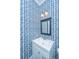 Stylish powder room with patterned wallpaper, a vanity with a white sink, and modern lighting at 2962 Clearwater Dr, Mount Pleasant, SC 29466