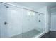 Large glass-enclosed shower with marble tiling, multiple shower heads and dark tile floors at 2962 Clearwater Dr, Mount Pleasant, SC 29466