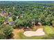 Aerial view showcasing the community with lush greenery and a nearby sand trap at 322 Clubview Rd, Summerville, SC 29485
