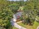 An aerial view showcases a red brick home nestled amidst lush greenery and a golf course, highlighting its prime location at 322 Clubview Rd, Summerville, SC 29485