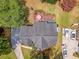 Overhead view of a home featuring a backyard deck, a driveway with parked cars, and a beautifully landscaped yard with mature trees at 322 Clubview Rd, Summerville, SC 29485