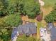 Aerial view captures a home with an outdoor deck, close to a golf course, surrounded by lush trees and parked cars at 322 Clubview Rd, Summerville, SC 29485