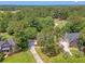 Aerial perspective showcasing a home surrounded by lush trees, with a golf course nearby and a view of the surrounding community at 322 Clubview Rd, Summerville, SC 29485