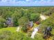 This aerial view highlights a home near a golf course, showcasing mature trees and the layout of the surrounding neighborhood at 322 Clubview Rd, Summerville, SC 29485