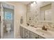 Bright bathroom featuring a double vanity, floral wallpaper and an adjacent toilet and shower area at 322 Clubview Rd, Summerville, SC 29485