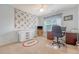 Bright room with ceiling fan, window, desk, and decorative quilt on the wall at 322 Clubview Rd, Summerville, SC 29485