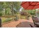Relax on the deck overlooking the golf course, complete with an outdoor umbrella and cozy seating area at 322 Clubview Rd, Summerville, SC 29485