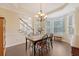 Bright dining room with hardwood floors, chandelier, large window, and staircase at 322 Clubview Rd, Summerville, SC 29485