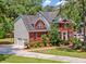 A well-manicured lawn and landscape adds to the curb appeal of this two-story brick home with an attached two-car garage at 322 Clubview Rd, Summerville, SC 29485