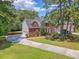 Charming two-story brick home boasts a well-maintained lawn, beautiful landscaping, and an inviting curb appeal at 322 Clubview Rd, Summerville, SC 29485