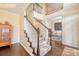 Spacious foyer with hardwood floors, carpeted staircase, and view into a study at 322 Clubview Rd, Summerville, SC 29485