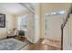 Bright foyer with hardwood floors and a front door with sidelights, adjacent to a cozy study at 322 Clubview Rd, Summerville, SC 29485