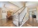 Bright foyer with hardwood floors, carpeted stairs, and dining room view featuring elegant chandelier and furniture at 322 Clubview Rd, Summerville, SC 29485