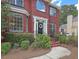 Elegant red brick home with a welcoming entrance, complete with a wreath, and manicured shrubs at 322 Clubview Rd, Summerville, SC 29485