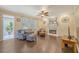 Cozy living room with hardwood floors, fireplace, ceiling fan, and access to sunroom at 322 Clubview Rd, Summerville, SC 29485