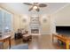 Bright living room features a fireplace, hardwood floors, and ceiling fan at 322 Clubview Rd, Summerville, SC 29485