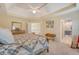 Comfortable main bedroom showcasing a quilt-covered bed, soft carpet, and access to the ensuite bathroom at 322 Clubview Rd, Summerville, SC 29485