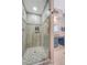 Glass enclosed shower with tile surround and decorative mosaic accents at 322 Clubview Rd, Summerville, SC 29485