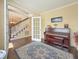 Sunlit study with hardwood floors, french doors, a view to the front foyer and a piano at 322 Clubview Rd, Summerville, SC 29485