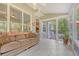 Comfortable sunroom with white tile floors, ceiling fan and natural light at 322 Clubview Rd, Summerville, SC 29485