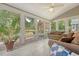Sunroom with white tile floors, ample natural light, ceiling fan, and views of the backyard at 322 Clubview Rd, Summerville, SC 29485