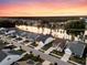 Aerial view of homes near a lake with sunset colors in the sky at 327 Tupelo Lake Dr, Summerville, SC 29486