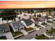 Expansive aerial perspective of a residential area by a lake, with evenly spaced homes and mature trees at 327 Tupelo Lake Dr, Summerville, SC 29486