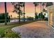 Gorgeous backyard featuring a patio with brick trim and a serene lake view at sunset at 327 Tupelo Lake Dr, Summerville, SC 29486