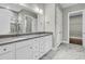 Elegant bathroom features double vanity, framed mirrors, stylish lighting and marble floors at 327 Tupelo Lake Dr, Summerville, SC 29486
