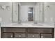 Well-lit bathroom features dual sinks, a modern vanity, and a view of the stylish tiled shower at 327 Tupelo Lake Dr, Summerville, SC 29486
