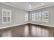 Bright bedroom features tray ceiling, wood floors, and shuttered windows offering beautiful views at 327 Tupelo Lake Dr, Summerville, SC 29486