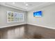 This spacious bedroom is enhanced by dark wood floors, natural light, and a modern ceiling fan at 327 Tupelo Lake Dr, Summerville, SC 29486