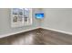 Bright bedroom with wood floors, shuttered windows and a tropical scene on the wall-mounted TV at 327 Tupelo Lake Dr, Summerville, SC 29486