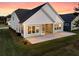 Back of home with screened in porch and large windows overlooking a manicured lawn at 327 Tupelo Lake Dr, Summerville, SC 29486