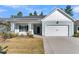Welcoming home featuring manicured lawn and an attached garage at 327 Tupelo Lake Dr, Summerville, SC 29486