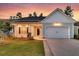 Inviting home exterior with a well-maintained lawn, elegant entryway, and attached garage at 327 Tupelo Lake Dr, Summerville, SC 29486