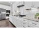 Bright kitchen features white cabinets, granite counters, stainless appliances and decorative subway tile backsplash at 327 Tupelo Lake Dr, Summerville, SC 29486