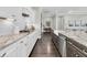 Modern kitchen featuring white cabinets, granite countertops, and stainless-steel appliances at 327 Tupelo Lake Dr, Summerville, SC 29486