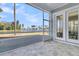 A relaxing screened patio overlooking a serene lake view with trees and clear blue sky at 327 Tupelo Lake Dr, Summerville, SC 29486
