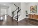 Staircase with dark wood treads and white risers, adjacent to a stylish sideboard at 327 Tupelo Lake Dr, Summerville, SC 29486