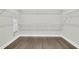 Walk-in closet offers ample storage with wire shelving and wood flooring at 327 Tupelo Lake Dr, Summerville, SC 29486