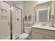 Modern bathroom featuring a glass-enclosed shower, white tile, and a sleek vanity with a framed mirror at 3307 Sawlog Dr, Summerville, SC 29486
