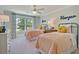 Charming bedroom featuring two twin beds, a ceiling fan, and a bright window with patterned curtains at 3307 Sawlog Dr, Summerville, SC 29486