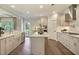 Bright, modern kitchen with stainless steel appliances, white cabinetry, island, and hardwood flooring at 3307 Sawlog Dr, Summerville, SC 29486