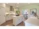 Bright, modern kitchen with stainless steel appliances, white cabinetry, island and a view of the dining area at 3307 Sawlog Dr, Summerville, SC 29486