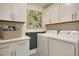 Bright laundry room includes ample cabinet space, a folding counter, and modern appliances at 3307 Sawlog Dr, Summerville, SC 29486