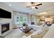 Bright living room featuring a cozy fireplace, large windows, and comfortable seating, ideal for relaxation at 3307 Sawlog Dr, Summerville, SC 29486