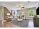 Spacious living room features a sectional sofa, plush rug, stylish lighting and a ceiling fan at 3307 Sawlog Dr, Summerville, SC 29486