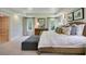 Bedroom featuring neutral décor, a tray ceiling, large windows, and an adjacent walk-in closet at 3307 Sawlog Dr, Summerville, SC 29486